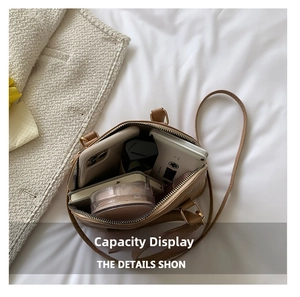 Interior view of brown quilted shell bag showing space for phone and makeup