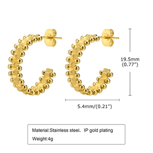Macro detail of 19.5mm C-hoop earrings in gold-plated stainless steel with beaded texture