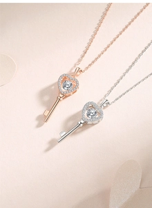 Detailed close-up of heart key necklaces in rose gold and silver finishes