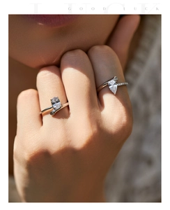 Detail of s925 silver rings with oval and teardrop zircon stones on model's hand