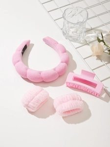 Detailed view of pink sponge headband, plush wristbands, and matte hair claw set