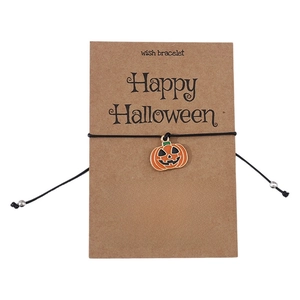 Close-up of Halloween wish bracelet with pumpkin charm on Happy Halloween card