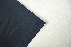 Close-up of fine stitching and high-density fabric texture on dark navy backless dress