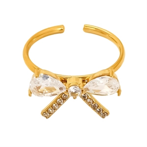 Elegant gold bow ring with pear-shaped gemstones and sparkling pave crystals on white background