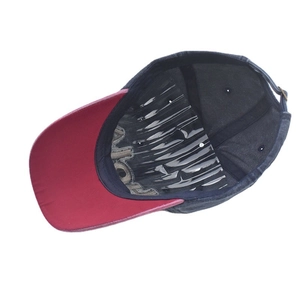 Detail of red and blue baseball cap showing internal embroidery and structured crown