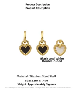 Detail of double-sided heart earrings with black and white shell inlay in gold titanium