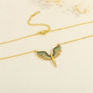 Detail of wing-shaped gold necklace with zircon stones and lobster clasp closure