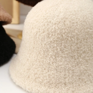 Women plush cream knitted bucket hat featuring soft sherpa texture and warm winter design