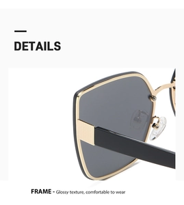 Detailed close-up of glossy black and gold cat-eye sunglasses with luxury metallic texture