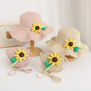 Detailed view of children's summer straw hat and matching bag with sunflower decoration