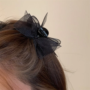 Elegant black organza bow hair claw clip for women's bun hairstyles shown in profile