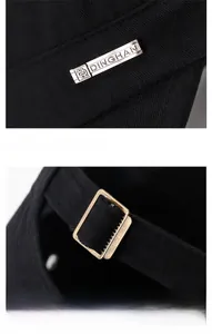 Detail of black flat top cap showing silver DINGHAN metal logo and bronze adjustable buckle