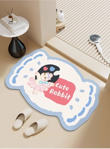 Detail of candy-shaped bath mat with cute rabbit cartoon and soft blue borders