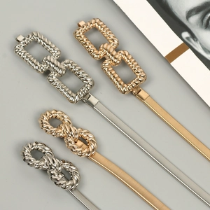 Detailed view of elastic metal waist chains in gold and silver with various buckle styles