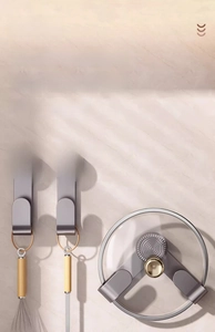 Macro detail of gunmetal kitchen lid rack with spiral texture on a marble wall
