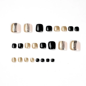 Elegante zwart en goud glitter plaknagels voor tenen met een artistiek lijndesign