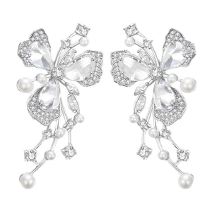 Elegant silver butterfly earrings with sparkling crystals and white pearls on white background