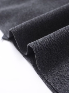 Detailed close-up of charcoal gray knit fabric texture showing premium soft material weave