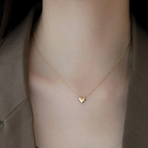 Classic 18K gold plated 925 sterling silver heart pendant necklace worn on a model's neck