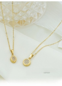Macro detail of gold titanium steel pendant necklaces with zircon inlay and chain link