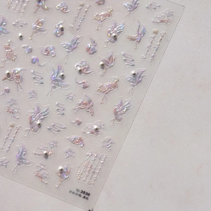 Detailed macro view of 5D embossed nail art stickers with laser crane and cloud patterns