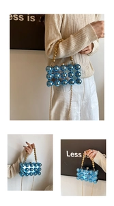 Detail of blue spherical acrylic bag with transparent body and gold beaded handle strap