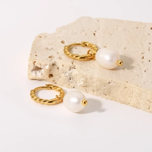 Detailed view of high-quality 18K gold-plated twisted hoop earrings with freshwater pearls