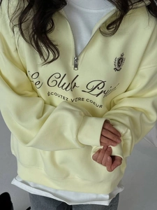 Light yellow half-zip sweatshirt with vintage varsity print and ribbed cuffs