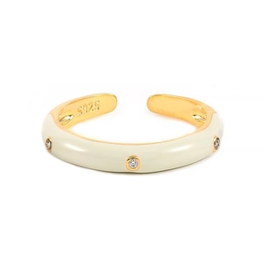 Detailed macro of 925 silver stamp on gold plated ring with white enamel and zircons
