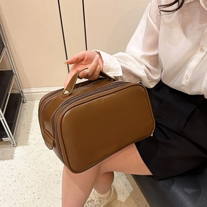 Portable brown faux leather makeup bag with large capacity and sturdy top handle