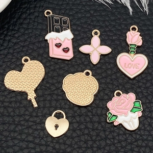 Detailed view of pink heart-shaped enamel alloy charms for DIY jewelry making