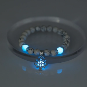 Luminous lotus charm bracelet with white turquoise beads and blue glowing effect