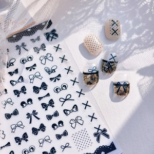 Minimalist black and white bow nail art stickers with lace and polka dot patterns