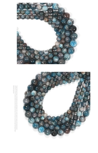 Macro shot of natural blue apatite round beads with unique stone texture on white background
