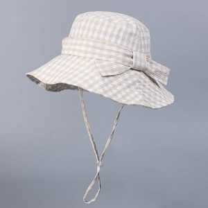 Detail of gingham bucket hat with bow accent and windproof strap for sun protection