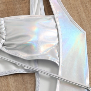 Close-up of holographic silver swimsuit fabric with metallic rainbow reflection details