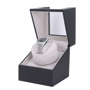 Macro shot of single watch winder featuring black leather texture and beige velvet lining
