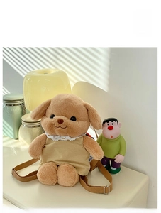 Detail of plush poodle backpack with brown adjustable straps in a warm domestic setting