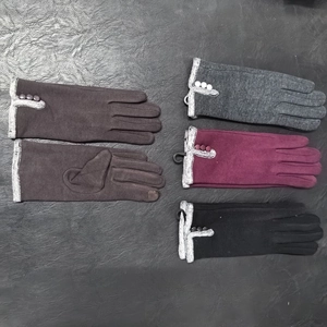 Detail showing touchscreen fingertips and three decorative buttons on winter knit gloves