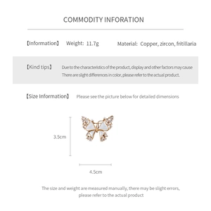 Detail showing 18k gold butterfly brooch dimensions 3.5cm by 4.5cm with mother of pearl