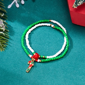 Detail of Christmas beaded bracelet set with red and green candy cane enamel charms
