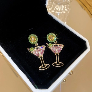 Detail of cocktail glass earrings with pink stones, pearls, and a lime slice accent