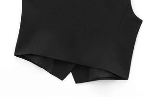 Detailed view of the black vest hem featuring premium woven fabric and sharp tailoring