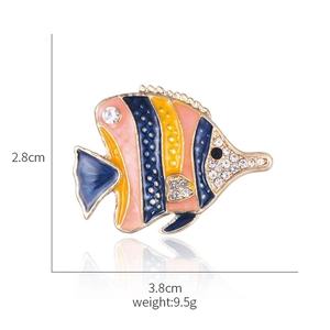 Detail of tropical fish enamel brooch with rhinestones and orange and navy finish