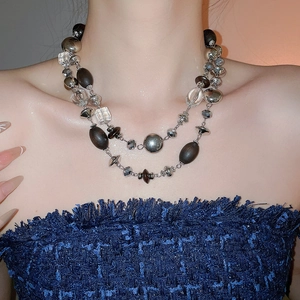 Detail of vintage double-layer beaded necklace featuring wood beads and crystals