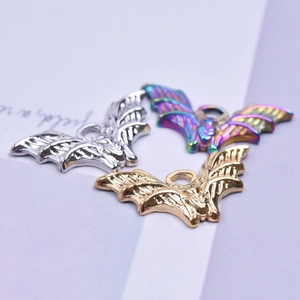 Detailed macro view of 18K stainless steel bat pendants in silver, gold, and rainbow colors