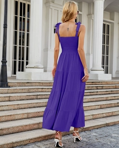 Detail of purple tiered maxi dress featuring bow shoulder straps and elastic back design