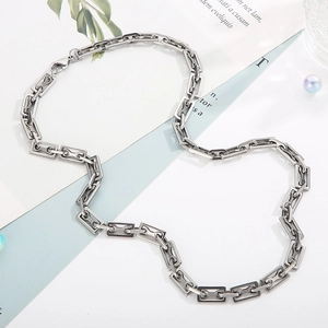 Detail of silver stainless steel geometric rectangular link chain with industrial design
