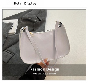 Detail view of a lavender purple glossy patent leather half-moon hobo bag with gold zipper