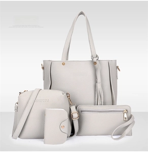 Detailed grey 4-piece faux leather bag set including tote with tassel and crossbody bag